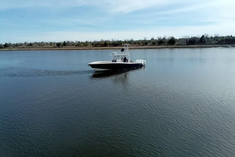 Slide: The Image of 2022 Invincible 39 Open Fisherman boat cruising on calm water under a clear sky. - 63