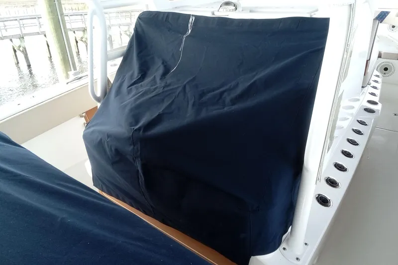 Slide: The Image of 2022 Invincible 39 Open Fisherman boat interior with covered console and rod holders. - 64