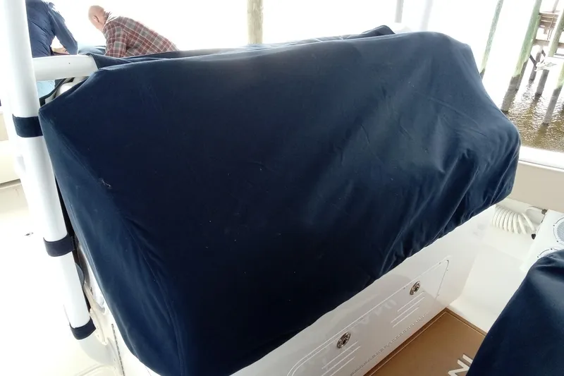 Slide: The Image of 2022 Invincible 39 Open Fisherman boat with covered console, docked near wooden posts. - 65