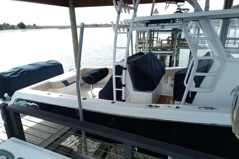 Slide: The Image of 2022 Invincible 39 Open Fisherman boat docked, featuring sleek design and covered seating. - 69