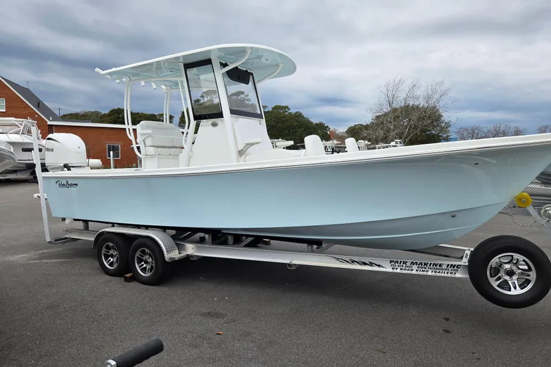 Slide: The Image of 2026 Pair Customs 24 Center Console MV boat on trailer, parked outdoors. - 0