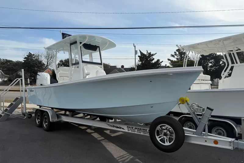 Slide: The Image of 2026 Pair Customs 24 Center Console MV boat on trailer, displayed outdoors. - 1