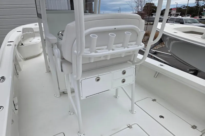Slide: The Image of 2026 Pair Customs 24 Center Console MV boat interior with rod holders and storage compartments. - 10