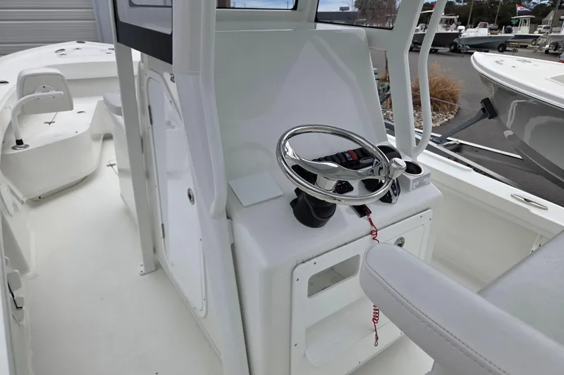Slide: The Image of 2026 Pair Customs 24 Center Console MV boat interior with steering wheel and controls. - 14
