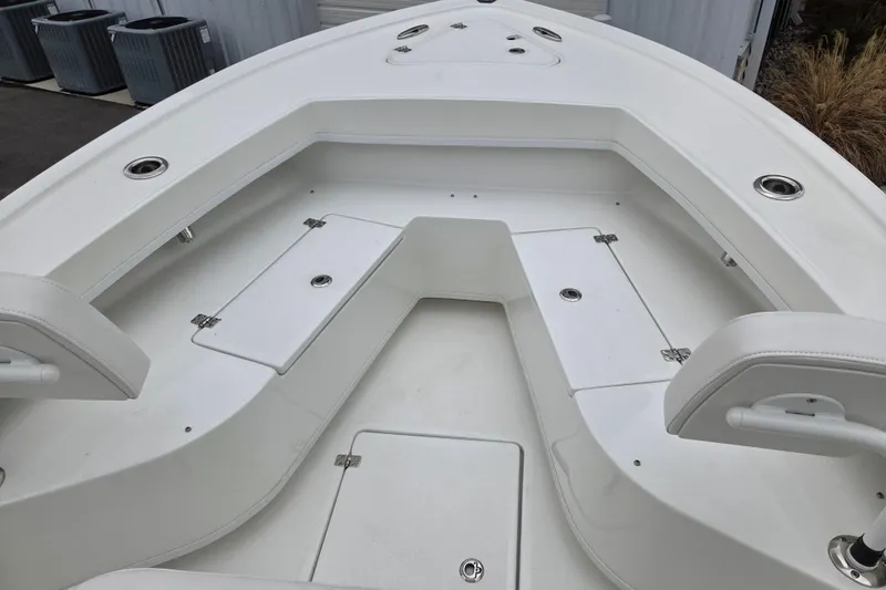 Slide: The Image of 2026 Pair Customs 24 Center Console MV boat interior with seating and storage compartments. - 17