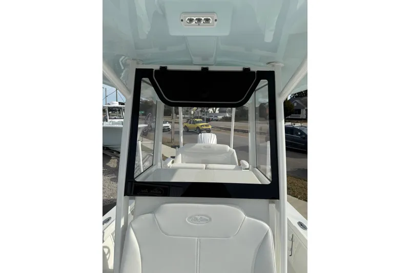 Slide: The Image of 2026 Pair Customs 24 Center Console MV interior with white seating and windshield view. - 2