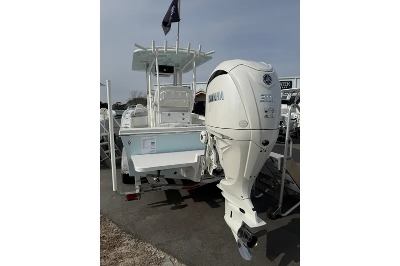 Slide: The Image of 2026 Pair Customs 24 Center Console MV boat with Yamaha 300 engine, displayed outdoors. - 6