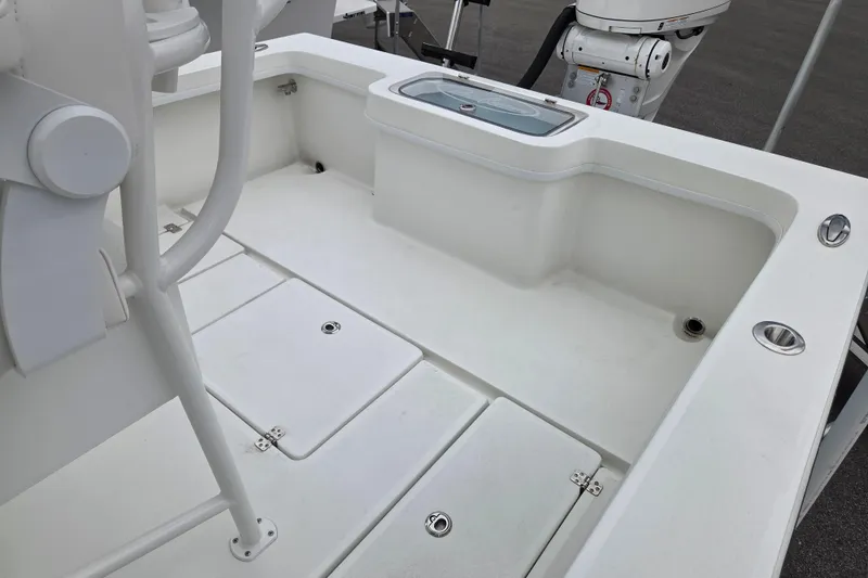 Slide: The Image of 2026 Pair Customs 24 Center Console MV boat interior with storage compartments. - 9