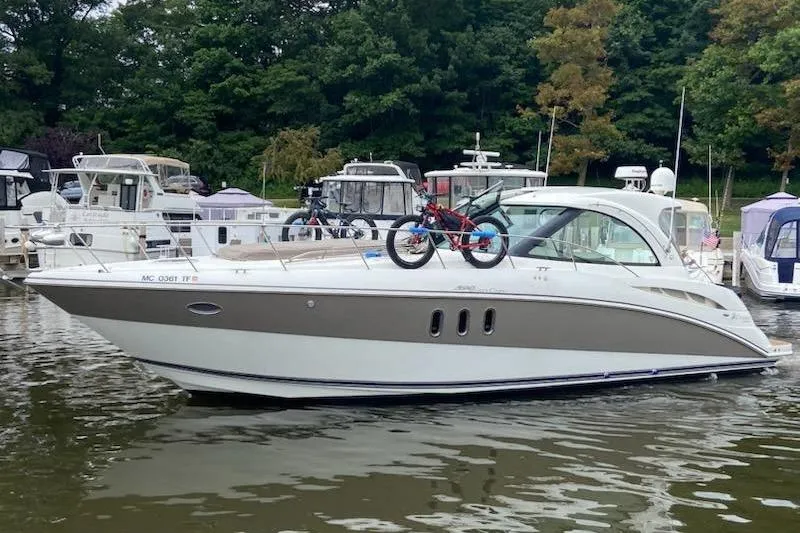 The Image of 2008 Cruisers Yachts 390 Sports Coupe docked with bicycles on deck. - 0