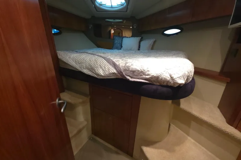 Slide: The Image of Luxurious cabin interior of 2008 Cruisers Yachts 390 Sports Coupe with cozy bed and wooden accents. - 17