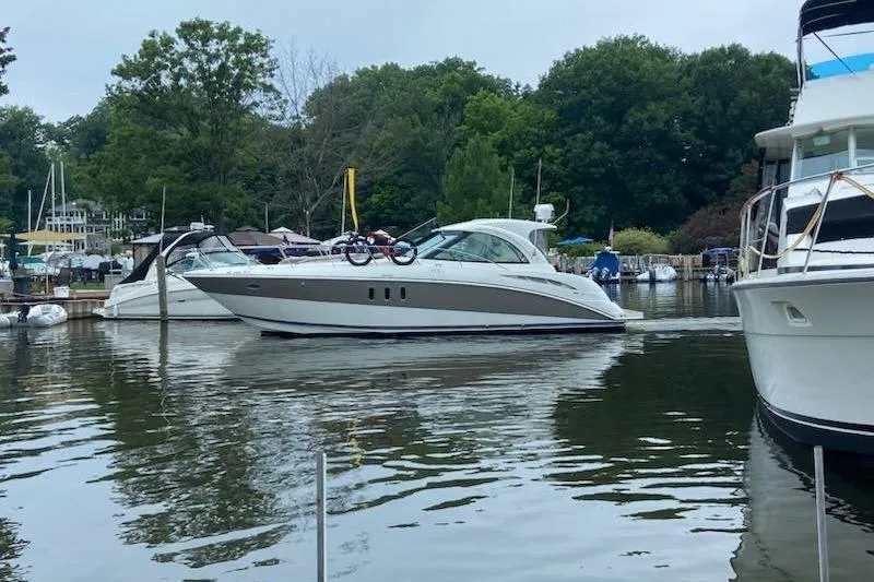 Slide: The Image of 2008 Cruisers Yachts 390 Sports Coupe docked in a serene marina setting. - 3