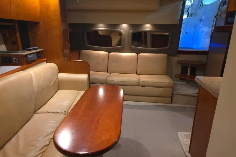 Slide: The Image of Interior of 2008 Cruisers Yachts 390 Sports Coupe with beige leather seating and wooden table. - 30