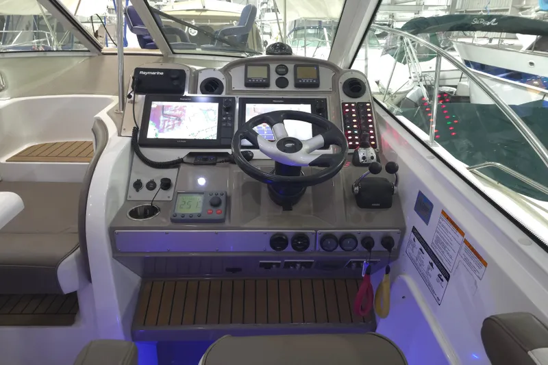 Slide: The Image of 2008 Cruisers Yachts 390 Sports Coupe helm with navigation equipment and steering wheel. - 46