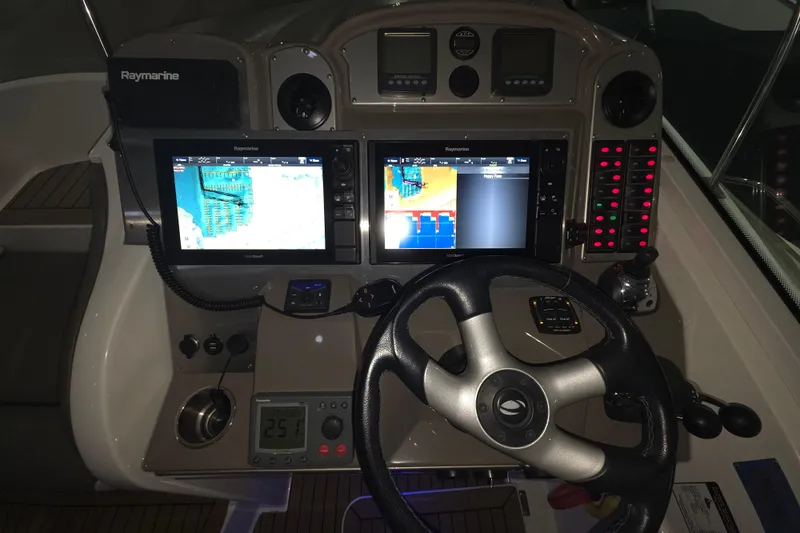 Slide: The Image of 2008 Cruisers Yachts 390 Sports Coupe helm with Raymarine navigation displays and controls. - 51