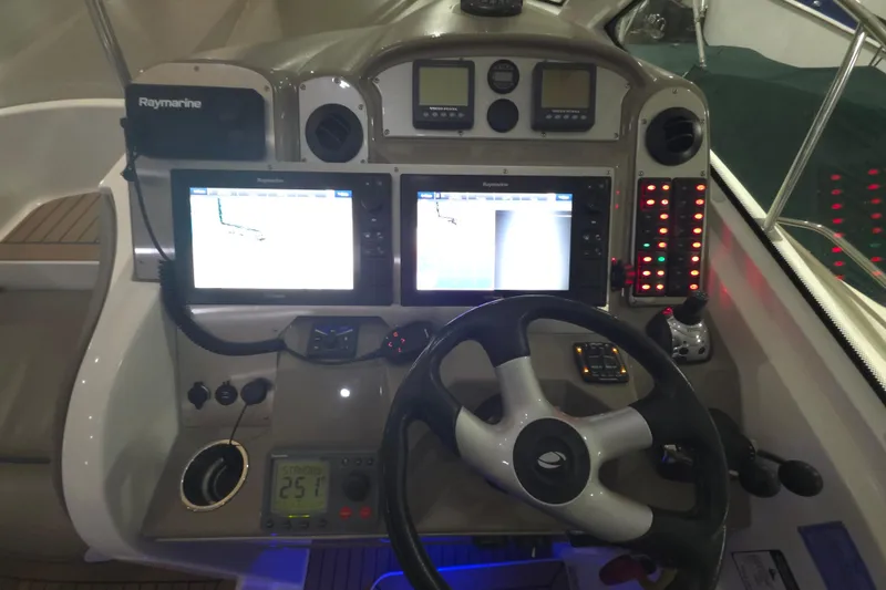 Slide: The Image of Control panel of 2008 Cruisers Yachts 390 Sports Coupe with navigation screens and steering wheel. - 50