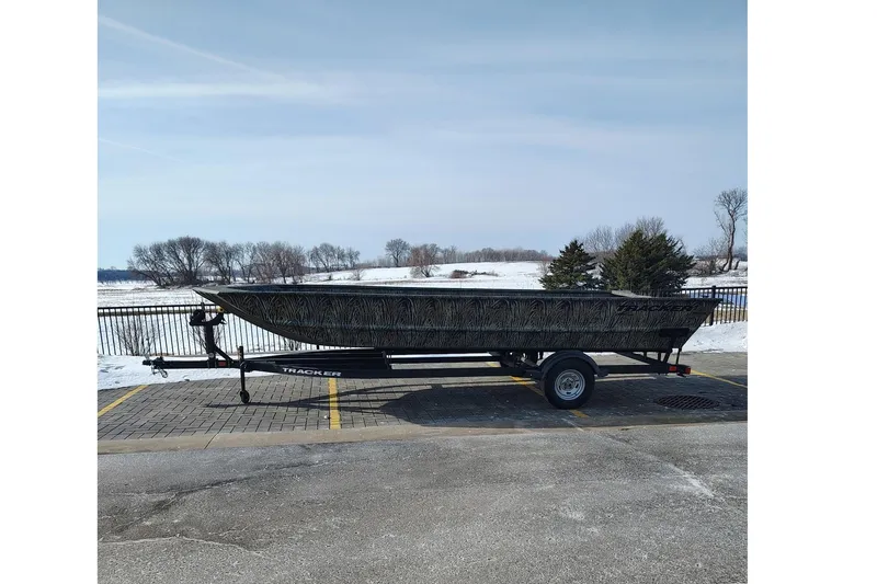 The Image of 2026 Tracker Grizzly 2072 Utility boat on trailer in snowy landscape. - 0