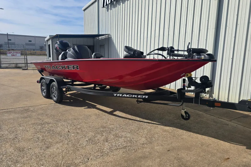 The Image of 2026 Tracker Pro Team 195 boat in red on a trailer, parked outdoors. - 0