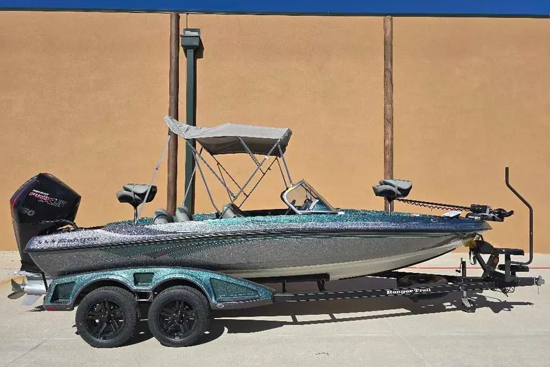 The Image of 2026 Ranger 212LS boat with canopy on trailer, parked outdoors. - 0