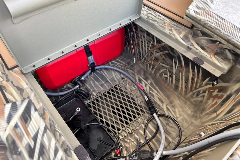 Slide: The Image of Interior view of 2026 Tracker Grizzly 1650 T Prairie Wings Edition boat storage compartment. - 17