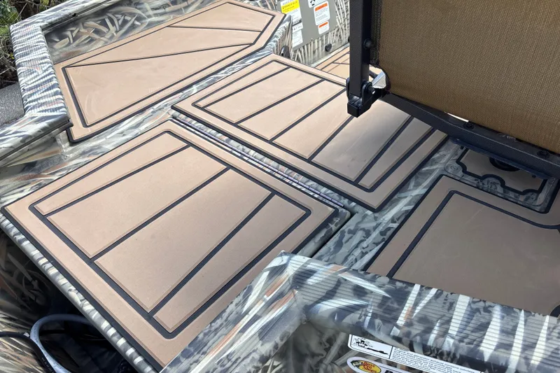 Slide: The Image of 2026 Tracker Grizzly 1650 T Prairie Wings Edition boat interior with camo design and padded flooring. - 18