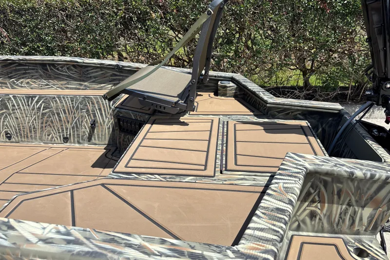 Slide: The Image of 2026 Tracker Grizzly 1650 T Prairie Wings Edition boat with camo design and seating. - 16