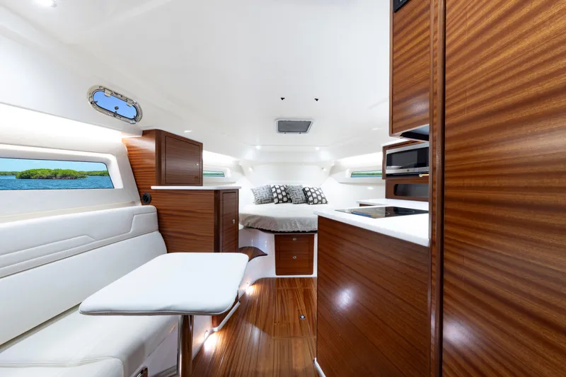 Slide: The Image of Luxurious interior of 2026 Pursuit OS 405 Offshore boat with wood finishes and modern amenities. - 10