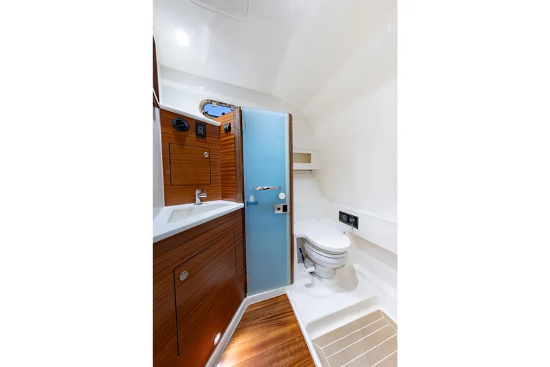 Slide: The Image of Luxurious bathroom in 2026 Pursuit OS 405 Offshore boat, featuring modern fixtures and wood accents. - 12