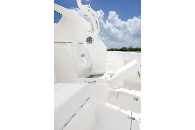 Slide: The Image of 2026 Pursuit OS 405 Offshore boat interior with white seating and storage compartments. - 7