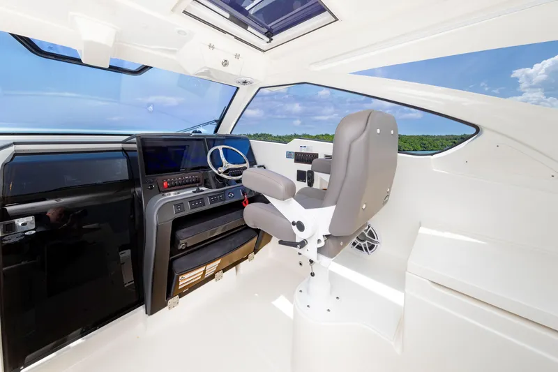 Slide: The Image of 2026 Pursuit OS 405 Offshore helm with modern controls and panoramic view. - 8