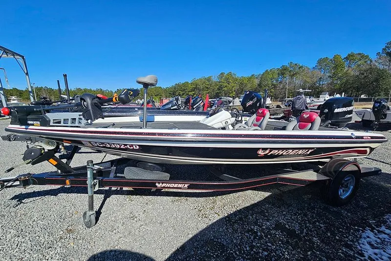 The Image of 2011 Phoenix 618 Pro fishing boat on trailer, parked outdoors under clear blue sky. - 1