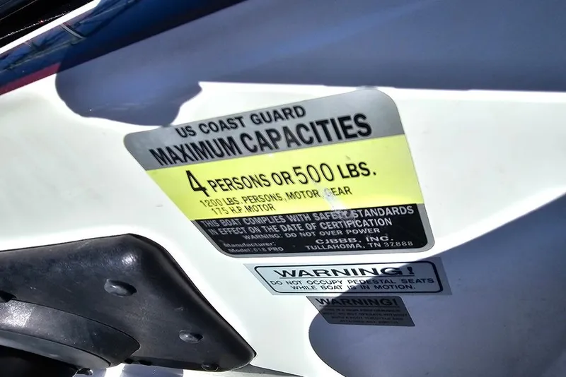 Slide: The Image of US Coast Guard capacity label on 2011 Phoenix 618 Pro boat, 4 persons or 500 lbs limit. - 11