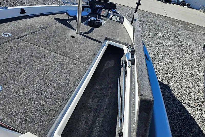Slide: The Image of 2011 Phoenix 618 Pro boat deck with open storage compartment and Minn Kota trolling motor. - 13