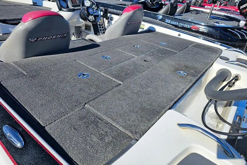 Slide: The Image of 2011 Phoenix 618 Pro boat interior with carpeted deck and branded seats. - 7