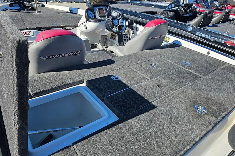 Slide: The Image of 2011 Phoenix 618 Pro boat interior with steering wheel and storage compartments. - 8