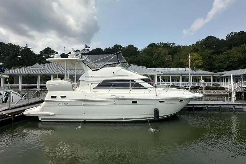 The Image of 2005 Cruisers Yachts 375 Motoryacht docked at marina, surrounded by trees and buildings. - 0