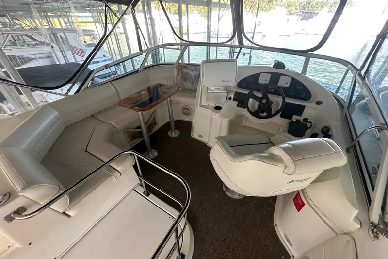 Slide: The Image of 2005 Cruisers Yachts 375 Motoryacht helm with seating, steering wheel, and navigation equipment. - 11