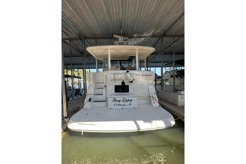 Slide: The Image of 2005 Cruisers Yachts 375 Motoryacht docked in a covered marina. - 2