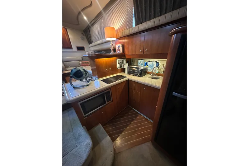 Slide: The Image of 2005 Cruisers Yachts 375 Motoryacht interior kitchen with wooden cabinets and modern appliances. - 7