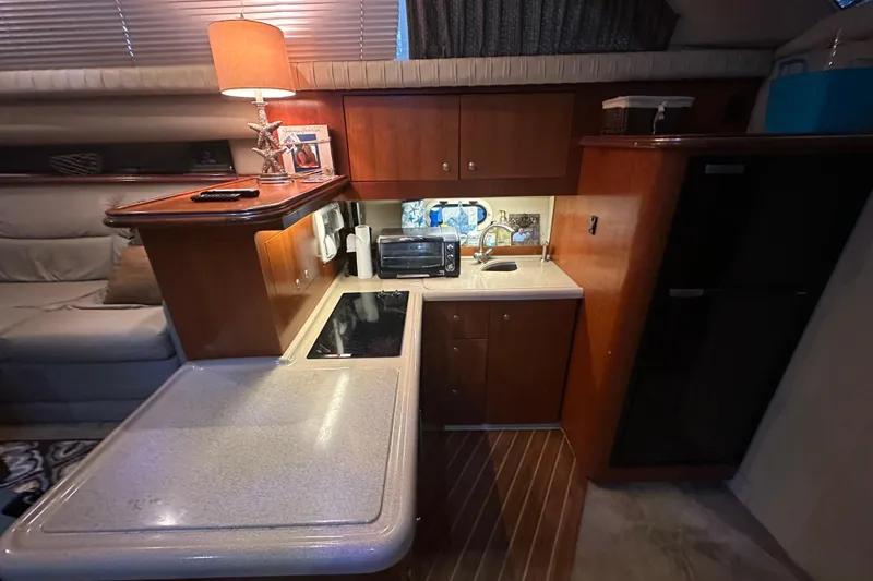 Slide: The Image of 2005 Cruisers Yachts 375 Motoryacht interior kitchen with wooden cabinets and modern appliances. - 8