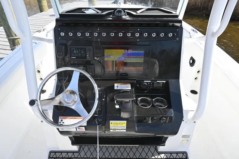 Slide: The Image of 2020 Wellcraft 222 Fisherman boat dashboard with steering wheel and navigation display. - 21