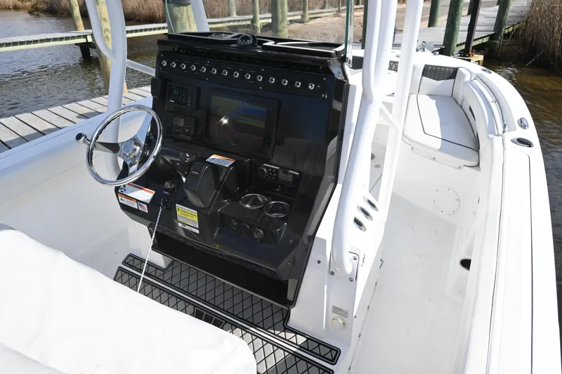Slide: The Image of 2020 Wellcraft 222 Fisherman boat console with steering wheel and navigation controls. - 22