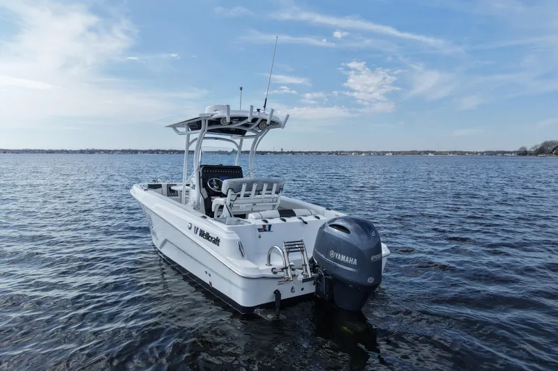 Slide: The Image of 2020 Wellcraft 222 Fisherman boat on calm water with Yamaha engine. - 6