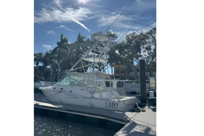 The Image of 2000 Cabo 35 Express boat docked under a clear blue sky. - 0