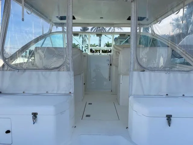 Slide: The Image of 2000 Cabo 35 Express boat interior with white seating and clear enclosures. - 10