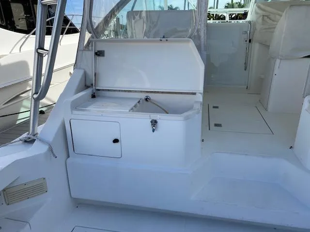 Slide: The Image of Cabo 35 Express 2000 model boat interior with storage compartments and seating area. - 11