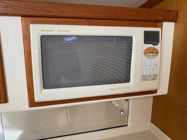 Slide: The Image of Built-in Sharp Carousel microwave in 2000 Cabo 35 Express boat kitchen. - 15