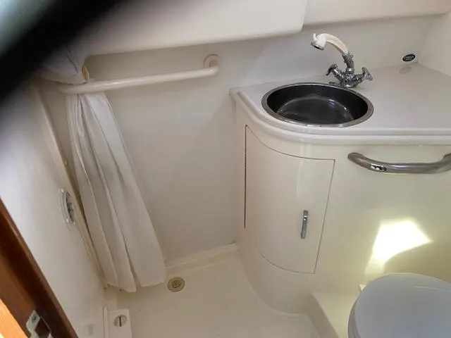 Slide: The Image of Compact bathroom in a 2000 Cabo 35 Express boat with sink and toilet. - 16