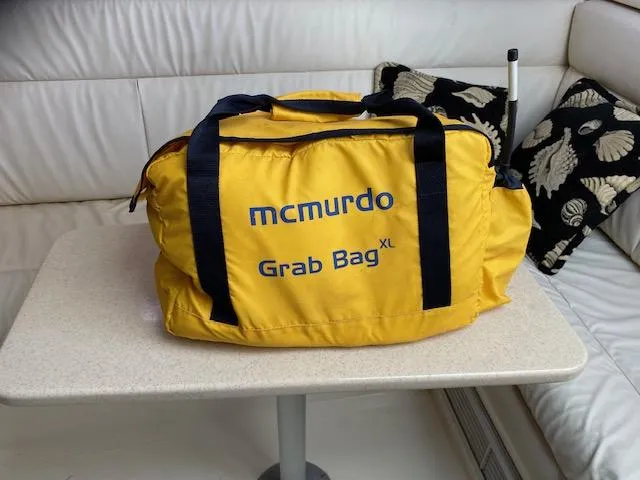 Slide: The Image of Yellow McMurdo Grab Bag XL on a table inside a 2000 Cabo 35 Express boat. - 20