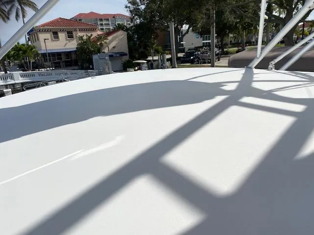 Slide: The Image of Top deck of a 2000 Cabo 35 Express boat in a marina. - 23