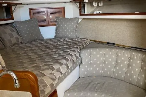 Slide: The Image of Cabo 35 Express 2000 interior cabin with bed and seating area. - 36